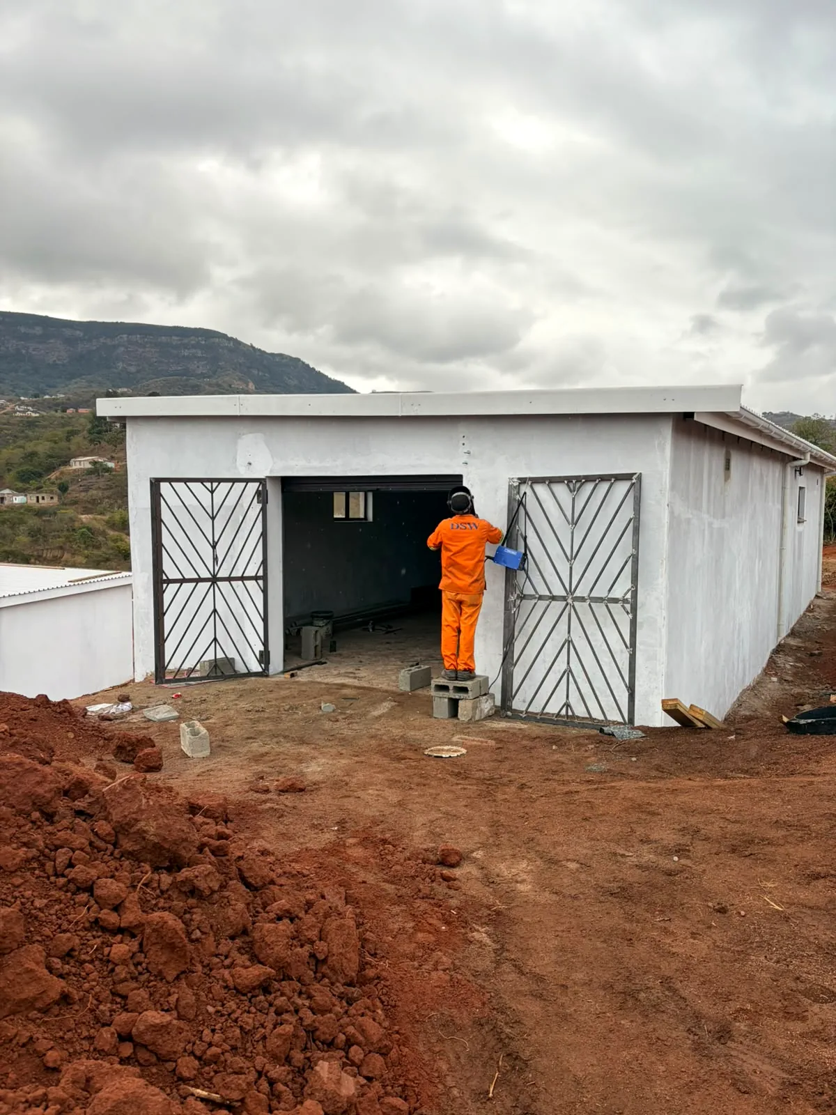 MADCON worker completing finishing work on a newly constructed building
